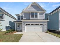 Two-story home with gray siding, white trim, and a two-car garage at 765 Opal Wing St, Moncks Corner, SC 29461