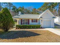 Cute one-story house with a gray roof, vinyl siding and a two-car garage at 8505 Mayfield Ct, North Charleston, SC 29406