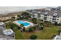 Aerial view of coastal community with pool and oceanfront location at 9000 Palmetto Dr # 103C, Isle of Palms, SC 29451