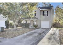 Beige two-story house with a garage and mature tree in the front yard at 112 Avonshire Dr, Summerville, SC 29483