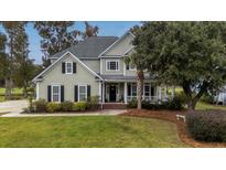 Two-story house with a large front porch and well-maintained lawn at 113 History Ln, Summerville, SC 29485