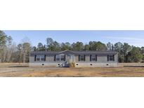 Newly constructed manufactured home with gray siding and black shutters at 120 Wilder Rd, Saint Stephen, SC 29479