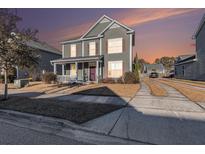 Two-story house with gray siding, a front porch, and a driveway at 1212 Topside Dr, Charleston, SC 29414