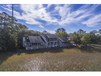 Aerial view of charming waterfront property with multiple units and marsh views at 1248 Creek Watch Trce, Seabrook Island, SC 29455