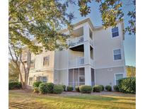 Tan three-story building with multiple balconies and landscaping at 1300 Park West Blvd # 1109, Mount Pleasant, SC 29466