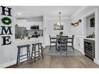 Open concept kitchen and dining area with stainless steel appliances and breakfast bar at 1300 Park West Blvd # 417, Mount Pleasant, SC 29466