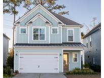 Two-story light teal house with white garage door and landscaping at 141 Low Tide Ct, Charleston, SC 29492