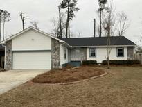 House exterior with a two-car garage and landscaping at 148 Ponderosa Dr, Ladson, SC 29456