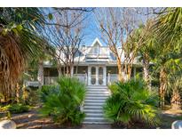 Charming two-story home with a wrap-around porch and lush landscaping at 2256 Ion Ave, Sullivans Island, SC 29482