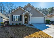 Craftsman style home with attached garage and manicured lawn at 2426 Tuscany Dr, North Charleston, SC 29406
