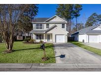 Two-story house with attached garage and well-maintained lawn at 247 Trickle Dr, Summerville, SC 29483