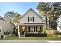 Charming craftsman style home with a brick facade and a welcoming front porch at 5103 Hyde Park Village Ln, North Charleston, SC 29405