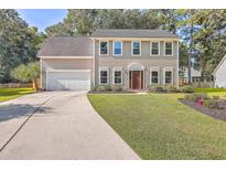 Two-story house with a neutral exterior, landscaped lawn, and driveway at 602 Leaning Pin Ct, Summerville, SC 29485