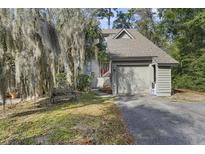 Exterior view of charming townhouse with attached garage and manicured lawn at 1031 Marsh Court Ln, Mount Pleasant, SC 29464