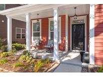 Inviting front porch with rocking chairs and hanging lanterns at 1687 Seabago Dr, Charleston, SC 29414