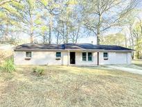 Charming ranch home with a well-manicured lawn and mature trees at 200 Elliott Dr, Ladson, SC 29456