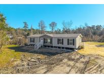 Single-wide manufactured home with neutral siding, white trim, and a deck at 240 Carolina Dr, Saint Stephen, SC 29479