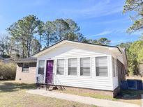 Charming one-story home with white siding and purple door at 348 Cleveland St, Walterboro, SC 29488