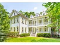 Two-story white house with green shutters, large porch, and lush landscaping at 376 Beresford Woods Ln, Charleston, SC 29492