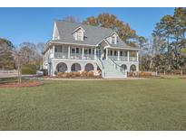 Two story home with wrap around porch and spacious yard at 3980 River Rd, Johns Island, SC 29455