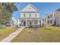 Two-story house with gray siding, front porch, and landscaped yard at 459 Spring Hollow Dr, Charleston, SC 29492