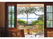 Waterfront view from a relaxing balcony, furnished with comfortable seating at 14 1/2 Murray Blvd, Charleston, SC 29401