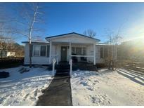 White single story home with front porch, snow covered yard, and wooden fence at 141 Nottingham Ln, Yemassee, SC 29945