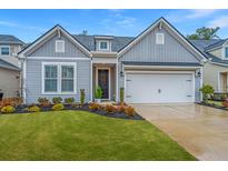 Gray sided home with white garage door and landscaped lawn at 178 Wappoo Trace Ln, Summerville, SC 29486