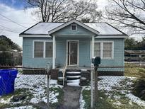 Light blue house with porch, steps, and fenced yard at 2007 Riverview Ave, North Charleston, SC 29405