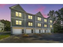 Three-story townhome building with attached garages and neutral colors at 202 Cache Ct # 2, Charleston, SC 29414