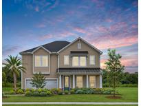 Two-story house with a taupe exterior, dark metal roof, and landscaping at 472 White Magnolia St, Moncks Corner, SC 29461