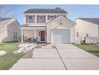 Two-story house with a yellow exterior, red door, and attached garage at 111 Brittondale Rd, Summerville, SC 29485
