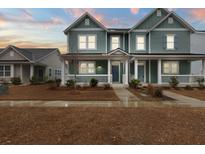 Two-story house with light teal siding, white trim, and a porch at 312 Parish Farms Dr, Summerville, SC 29486