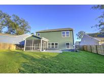 Spacious backyard with screened porch and grassy area at 5440 Overland Trl, North Charleston, SC 29420