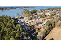 Aerial view of waterfront community with homes and lush trees at 601 Levee Dr, Moncks Corner, SC 29461