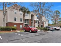 Tan building exterior with red brick bottom, featuring ample parking at 2011 N Highway 17 # 2100Q, Mount Pleasant, SC 29466
