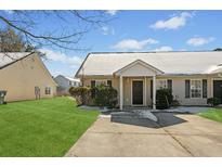 Tan house with a green lawn and snow on the roof at 309 Julia Caroline Ave # A, Moncks Corner, SC 29461