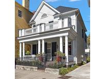 Two-story home with white siding, balcony, and ornate iron fence at 40 S Battery St, Charleston, SC 29401