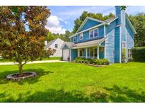 Beautiful two-story blue home with a well-manicured lawn and mature tree at 458 Mount Royal Drive Dr, Mount Pleasant, SC 29464