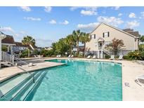 Community pool with ample lounge chairs and surrounding landscaping at 534 Mclernon Trace, Johns Island, SC 29455