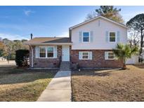 Newly renovated two-story house with brick and siding at 3247 Poindexter Rd, North Charleston, SC 29420