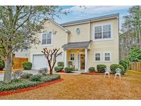 Two-story yellow house with attached garage and landscaped yard at 3312 Middlesboro Ave, Summerville, SC 29485