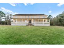 Two-story house with a large front porch and expansive lawn at 3687 Hilton Dr, Johns Island, SC 29455