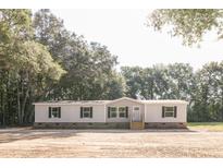 Single-wide manufactured home with gray siding, white trim, and stone accents at 414 Caties View Way, Moncks Corner, SC 29461