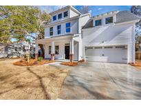 Two-story white house with gray roof, two-car garage, and landscaped yard at 5294 Seewee Rd, Awendaw, SC 29429