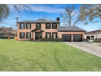 Brick house with a two-car garage and manicured lawn at 1 Hunters Forest Dr, Charleston, SC 29414