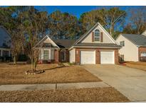 Brick ranch house with two-car garage and well-maintained lawn at 114 Guildford Dr, Goose Creek, SC 29445