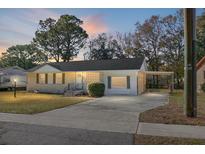 Charming one-story home with a carport and well-manicured lawn at 1513 Secessionville Rd, Charleston, SC 29412