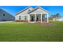 Gray house with a front porch, green lawn, and mature trees at 2020 Parish House Cir, Johns Island, SC 29455