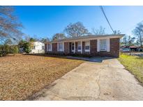 Brick ranch house with driveway and mature trees at 204 Palmetto St, Moncks Corner, SC 29461